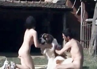 Naked couple gets ready for a sex session with a huge dog outdoors