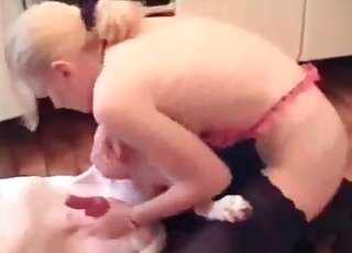 Blond zoophile grabs dog's hard shaft and start sucking it with joy