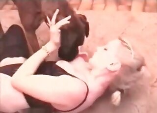 Blonde lays down on the floor and lets her dog fuck her pussy